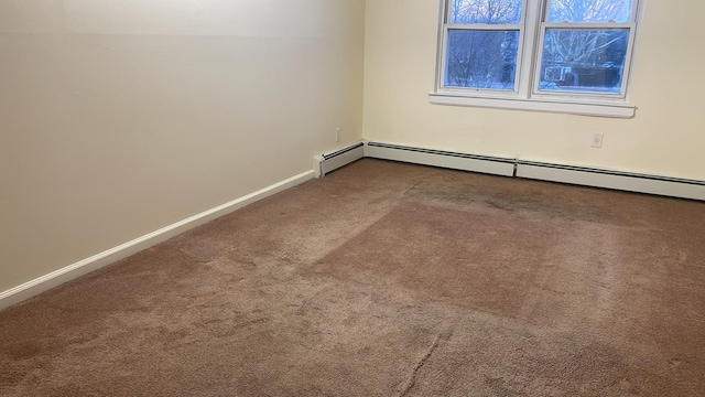 carpeted empty room with baseboard heating