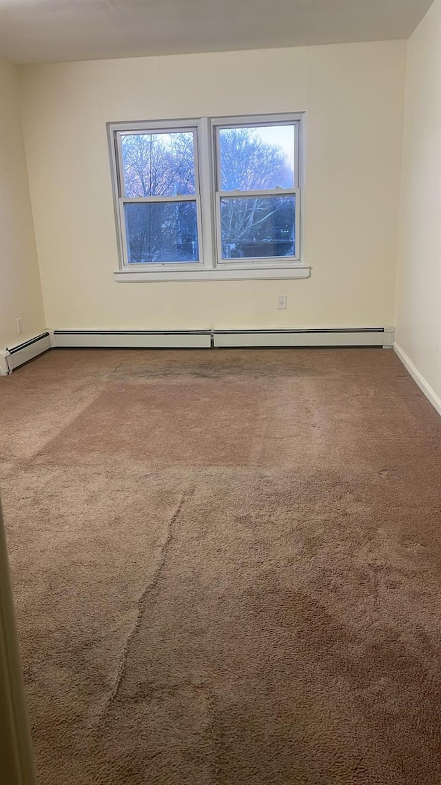 spare room with a baseboard radiator and carpet flooring