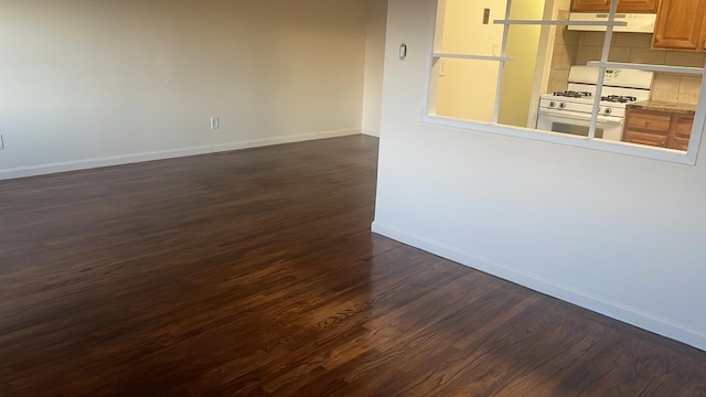 unfurnished room with dark hardwood / wood-style floors