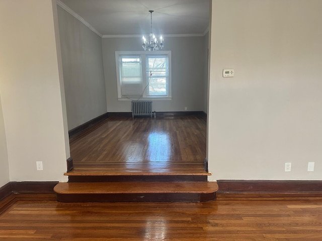 interior space featuring a chandelier, radiator heating unit, crown molding, and hardwood / wood-style floors