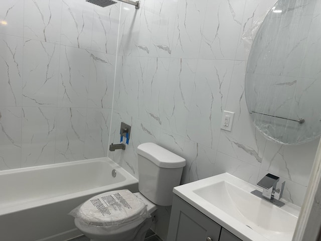 full bathroom with vanity, toilet, tile walls, and tiled shower / bath combo