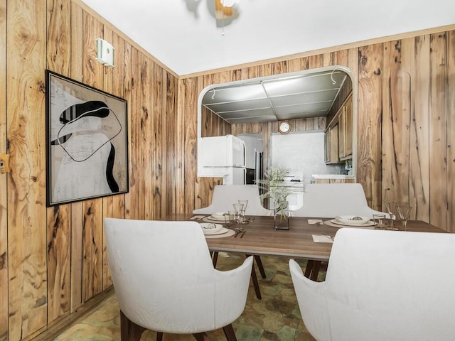 dining room with wood walls