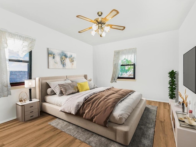 bedroom with ceiling fan and light hardwood / wood-style floors