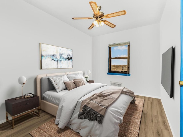 bedroom featuring hardwood / wood-style flooring and ceiling fan