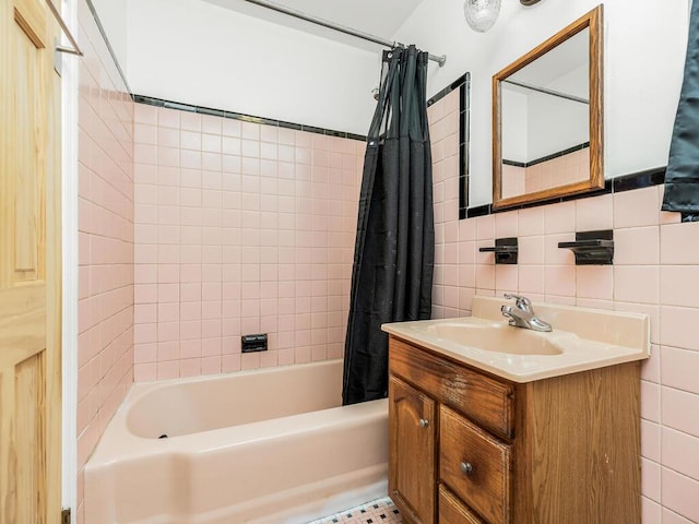 bathroom featuring shower / tub combo, vanity, and tile walls