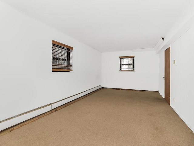 spare room featuring carpet flooring and baseboard heating