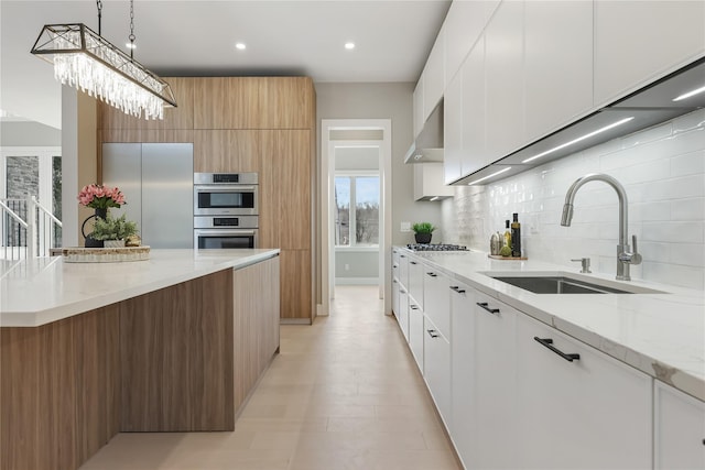 kitchen with sink, white cabinets, tasteful backsplash, and appliances with stainless steel finishes