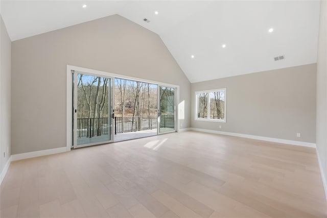 unfurnished living room with high vaulted ceiling and light hardwood / wood-style flooring