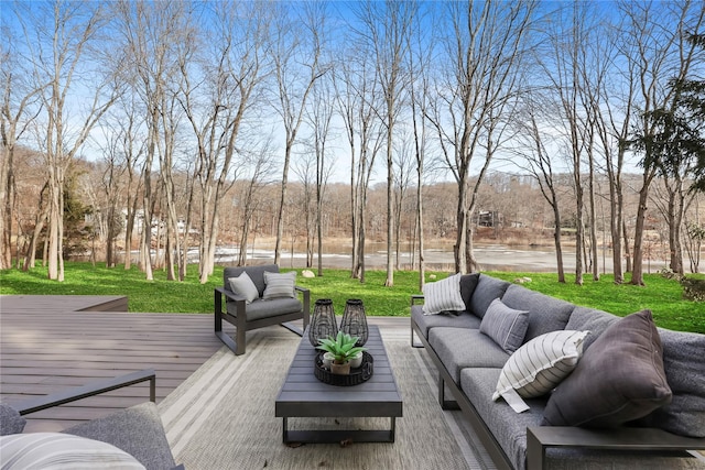 wooden deck with an outdoor living space and a yard