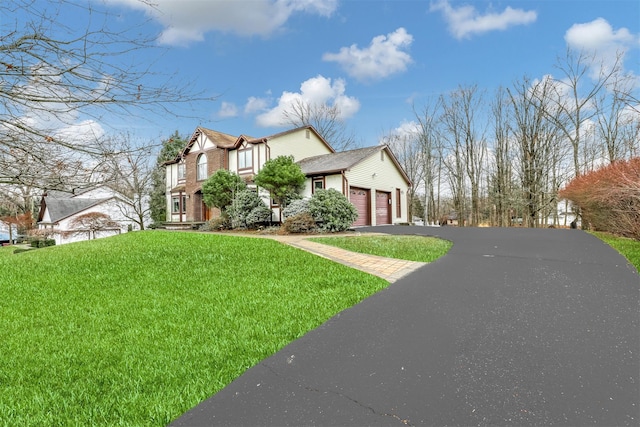 view of front of house with a garage and a front lawn