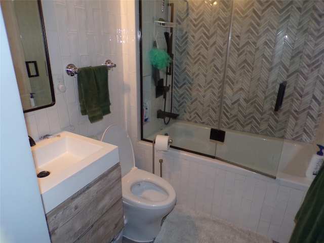 full bathroom with vanity, toilet, and bath / shower combo with glass door