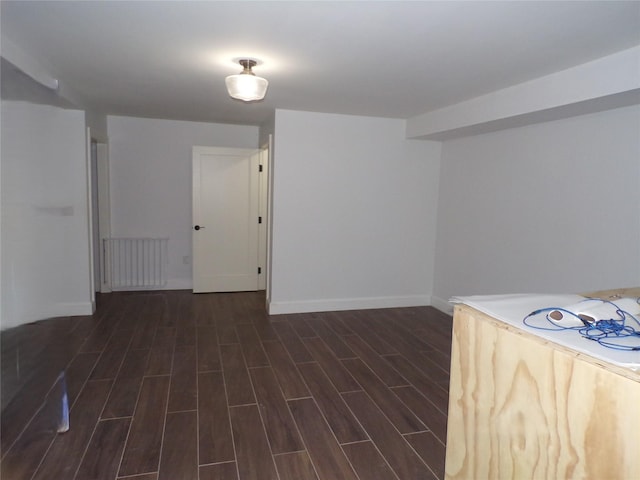 interior space featuring radiator heating unit and dark wood-type flooring