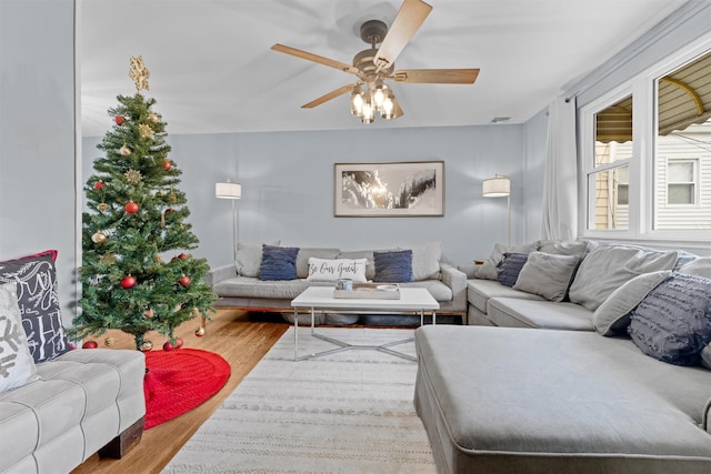 living room featuring hardwood / wood-style floors and ceiling fan