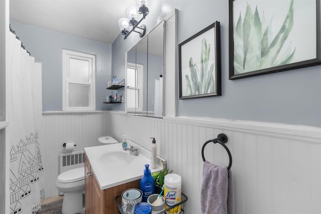 bathroom featuring vanity, toilet, radiator heating unit, and an inviting chandelier