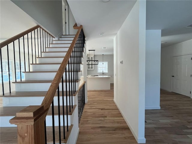 stairway with hardwood / wood-style flooring