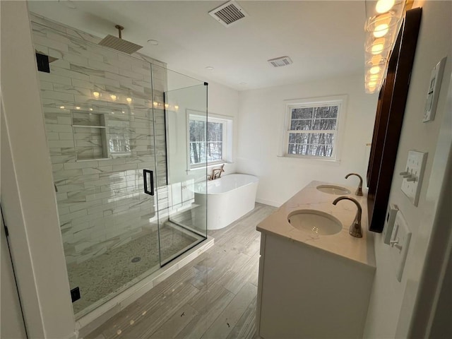 bathroom featuring vanity, wood-type flooring, and independent shower and bath