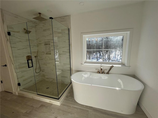 bathroom with hardwood / wood-style floors and plus walk in shower