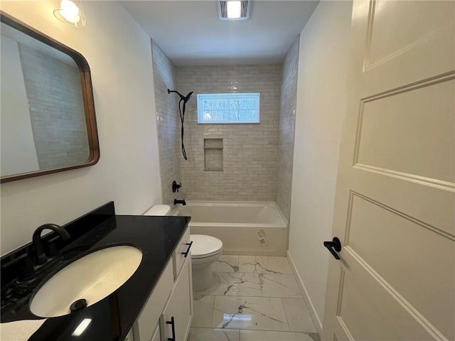 full bathroom featuring vanity, tiled shower / bath combo, and toilet