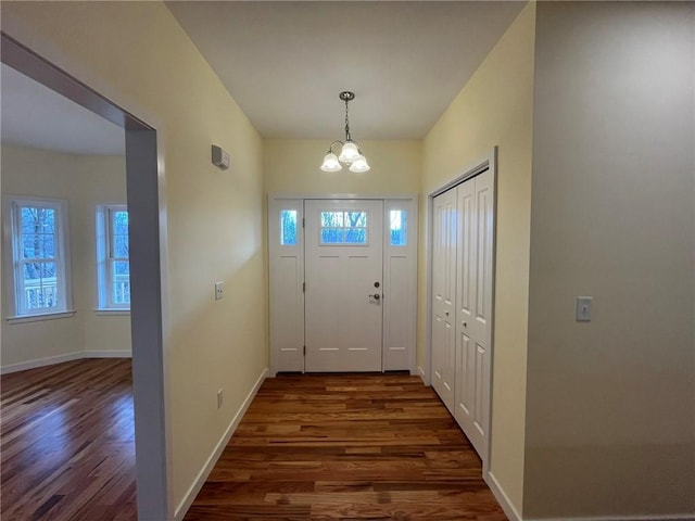 entryway featuring a notable chandelier and dark hardwood / wood-style floors