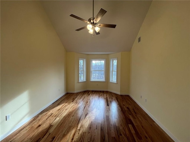 spare room featuring hardwood / wood-style flooring, vaulted ceiling, and ceiling fan