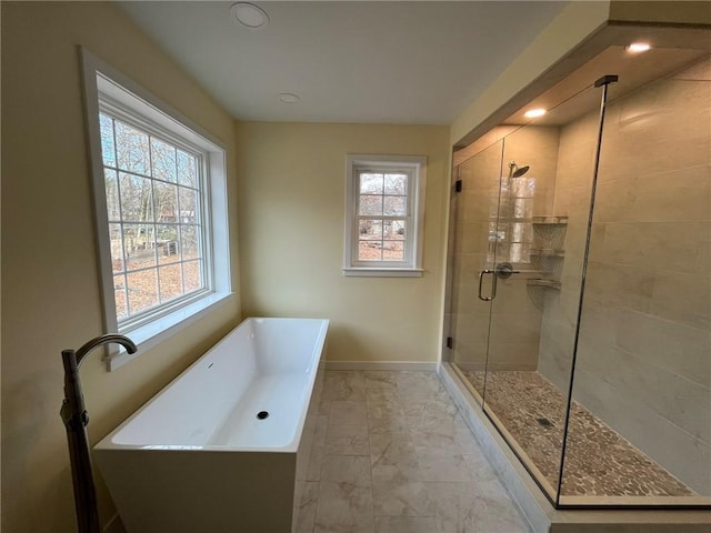 bathroom featuring independent shower and bath