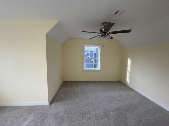 additional living space with light carpet, vaulted ceiling, and ceiling fan