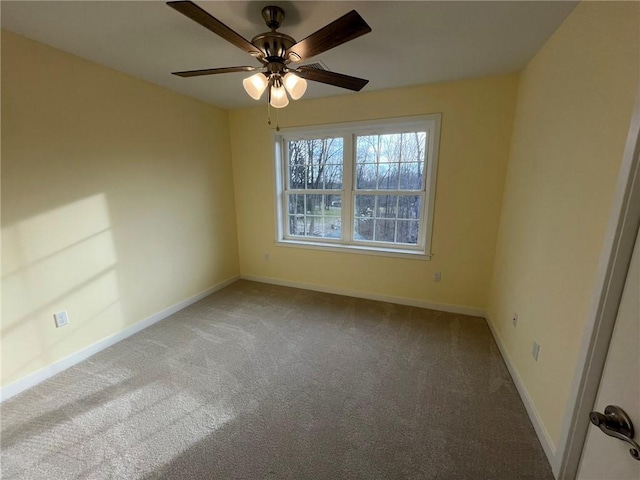 carpeted spare room with ceiling fan