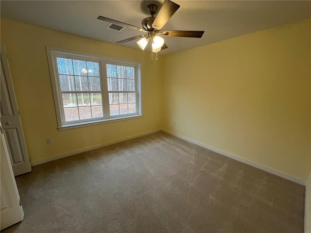 carpeted spare room with ceiling fan