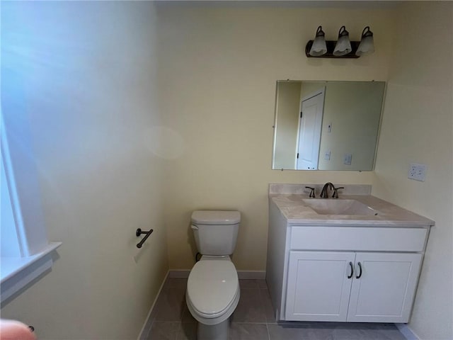 bathroom featuring tile patterned floors, vanity, and toilet