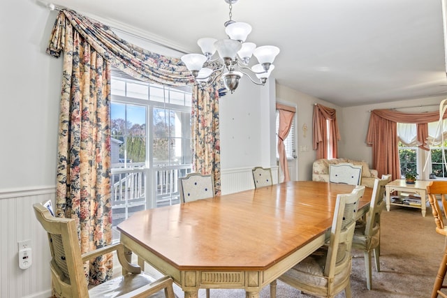 dining room featuring carpet flooring, an inviting chandelier, and plenty of natural light