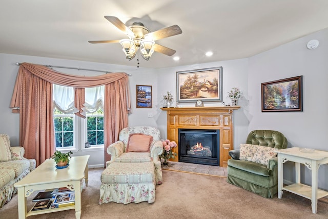 sitting room featuring ceiling fan and light colored carpet