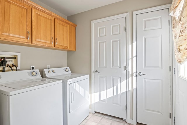 laundry room with washer and dryer and cabinets