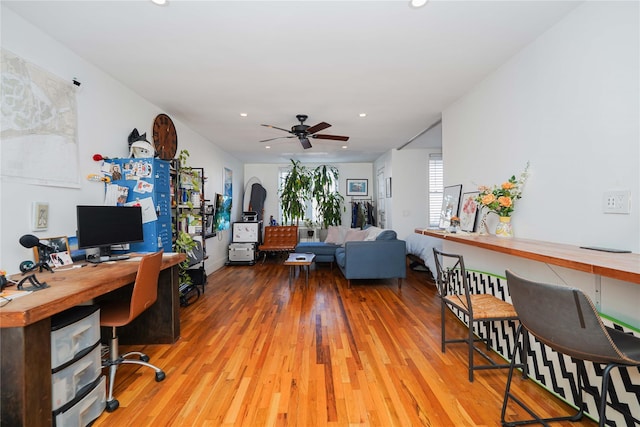 home office featuring hardwood / wood-style floors and ceiling fan