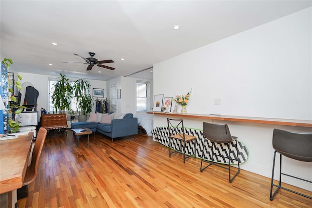 living room featuring hardwood / wood-style flooring and ceiling fan