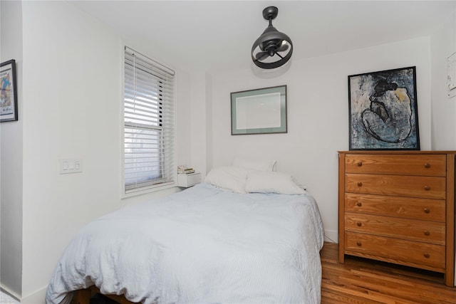 bedroom with hardwood / wood-style floors