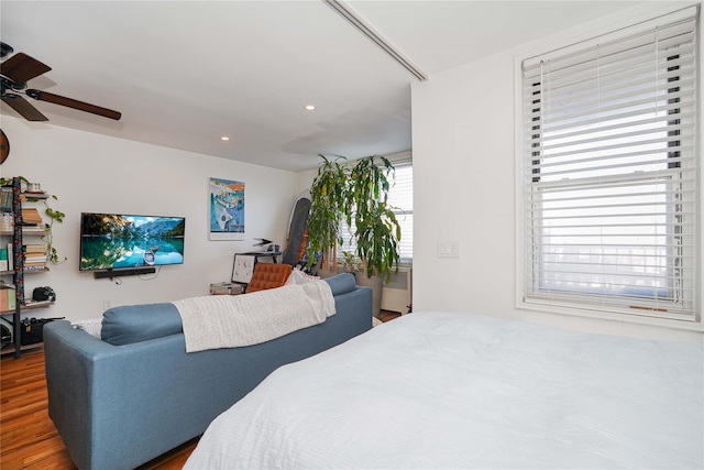 bedroom with ceiling fan and dark wood-type flooring