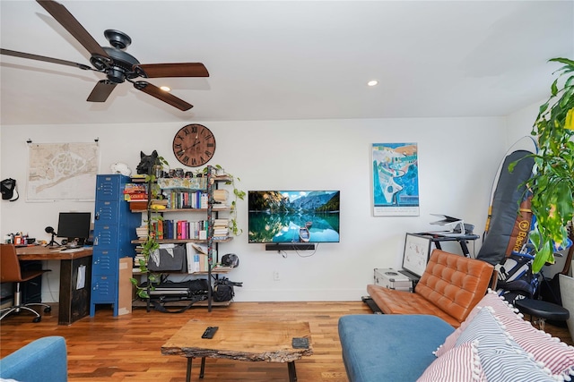 living room featuring hardwood / wood-style flooring and ceiling fan