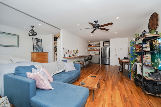 living room featuring ceiling fan and wood-type flooring