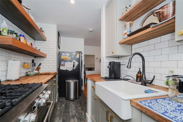 kitchen with backsplash, sink, stainless steel appliances, and dark hardwood / wood-style floors