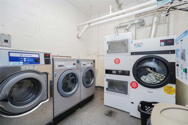 130 Bch 121st St Unit 2B, Rockaway Beach, NY 11694 - community laundry room with independent washer and dryer, estacked washer and dryer, and concrete block wall