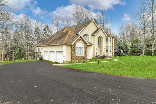 front of property with a front yard and a garage