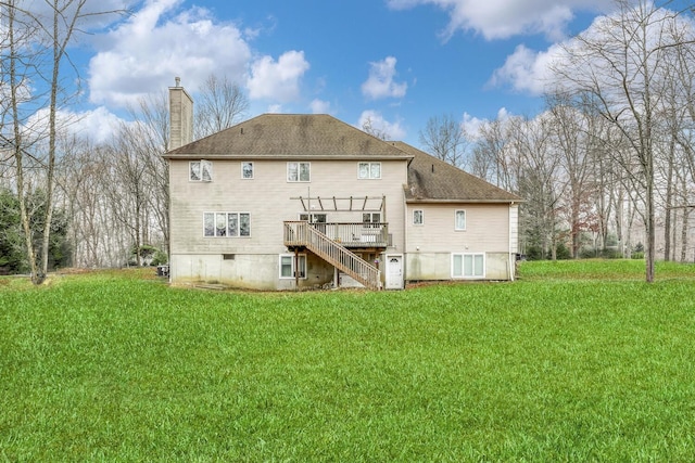 rear view of property featuring a yard and a wooden deck