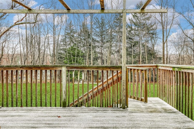 wooden deck featuring a lawn