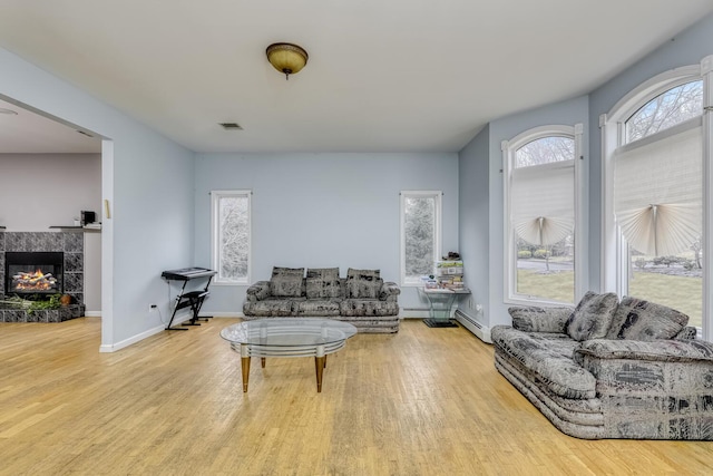 living room with a fireplace and light hardwood / wood-style floors