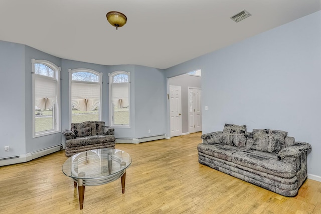 interior space featuring a baseboard radiator and light hardwood / wood-style flooring