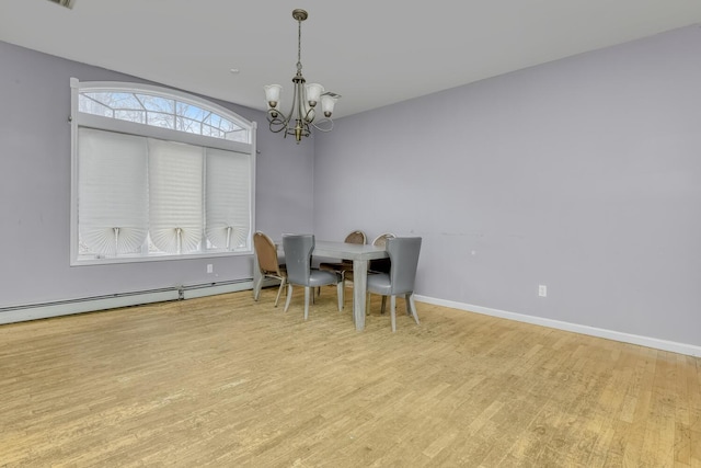 dining area featuring a baseboard radiator, light wood-type flooring, and a notable chandelier