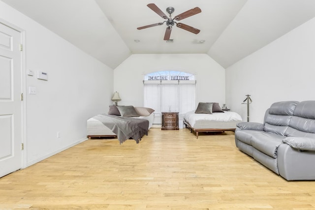 bedroom with light wood-type flooring, vaulted ceiling, and ceiling fan