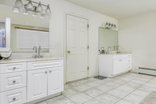 bathroom featuring tile patterned flooring, vanity, and baseboard heating