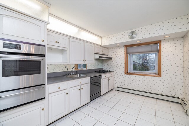 kitchen with sink, light tile patterned floors, baseboard heating, white cabinets, and black appliances