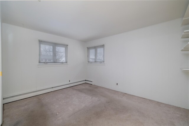 unfurnished room with light colored carpet and a baseboard radiator